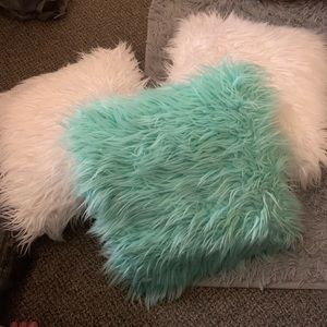 Two white pillows and one turquoise pillow